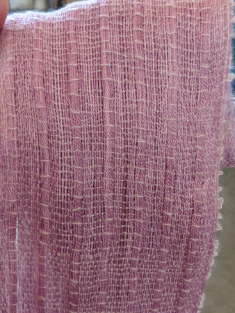 Betty's scarf has a mohair warp with stripes of warp cramming, a very light cotton weft, and fine beads on the fringe.