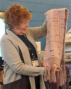 Using Terry's handspun yarn as warp and also as weft at each end, Joyce wove this scarf. It also featured slubs of roving to add more texture and interest.